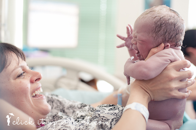 Newborn baby and mom in a beautiful birth photography shot.
