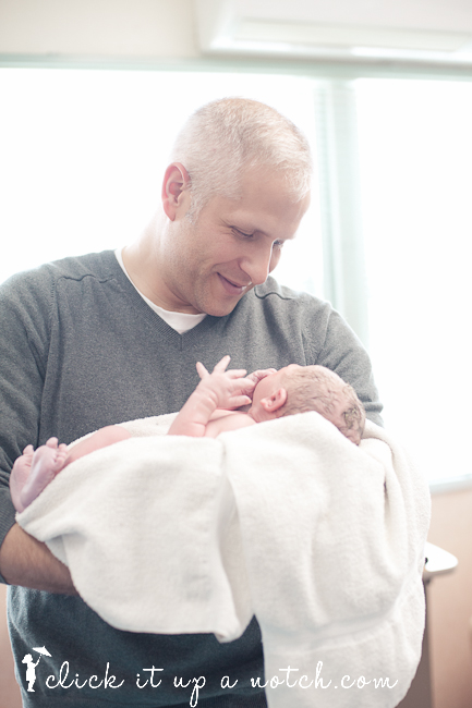 Dad holding a newborn baby.