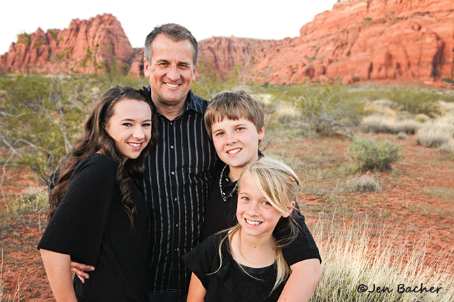 Group photo of a small family all coordinating wearing black